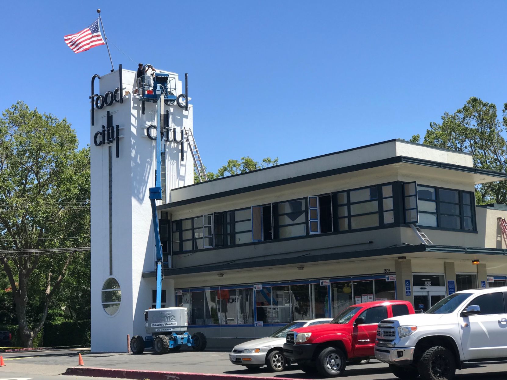 Workers finish installing vintage Food City letters at the south Napa center